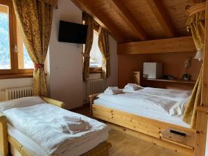 Postel nebo postele na pokoji v ubytování Garnì Costa Verde