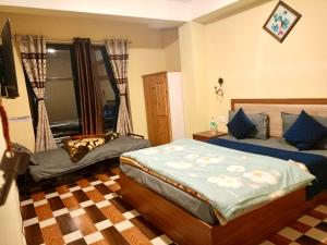Postel nebo postele na pokoji v ubytování Hotel Manjushree