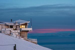 a house on top of a snow covered hill at Rifugio Chierego - 1911m in Brenzone sul Garda