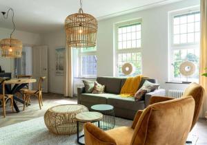 a living room with a couch and a table at In de Witte Dame Hotel Bar Kitchen Apartments in Grubbenvorst