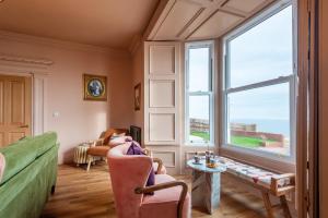 a living room with a couch and a window at One Roker Terrace in Monkwearmouth