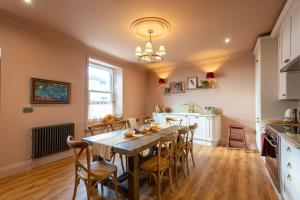 a kitchen and dining room with a wooden table and chairs at One Roker Terrace in Monkwearmouth