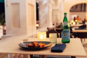 a table with a plate of food and a glass of wine at Rosedon - Adults Only from Jan 2025 in Hamilton