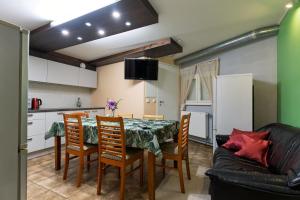 a kitchen and dining room with a table and chairs at IDA Apartments in Kuressaare