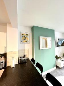 a kitchen with a table and chairs in a room at Town Centre Apartments by the Beach, BIC, Pavilion in Bournemouth