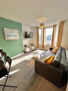 a living room with a couch and a tv at Town Centre Apartments by the Beach, BIC, Pavilion in Bournemouth