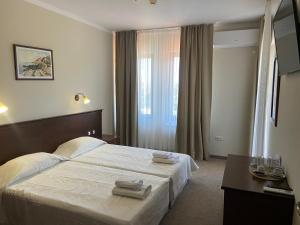 a hotel room with a bed with towels on it at Villa Maria Revas in Sunny Beach +66 photos