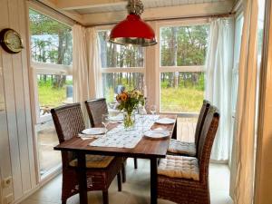 a dining room with a table and chairs and a window at Sandrose - Baabe in Baabe