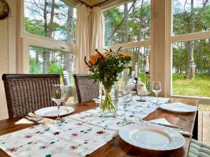 a dining room table with a vase of flowers on it at Sandrose - Baabe in Baabe