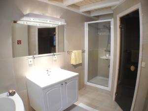 a bathroom with a white sink and a shower at Sandrose - Baabe in Baabe