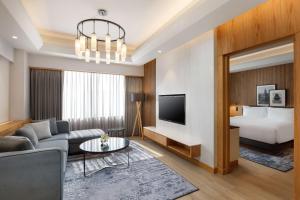 a living room with a couch and a bed at Radisson Hotel Kathmandu in Kathmandu