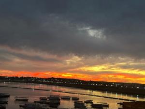 a sunset over a harbor with boats in the water at Villa Misk in Aswan