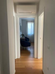 a view of a living room with a blue couch at Eudaimonia Apartments Fratte in Santa Giustina in Colle +12 photos