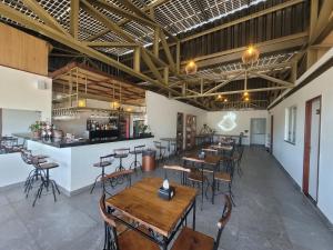 a restaurant with tables and chairs and a bar at Hotel Sea Angels in Arraial do Cabo