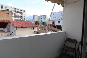 a room with a balcony with a view of buildings at Apartment Rita Berat in Berat