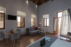 a living room with a couch and a table at Bluebell Luxury Suites in Chania