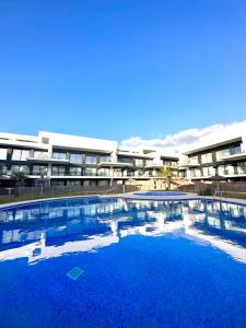 a large swimming pool in front of a building at Zahareña Zen House - Ático Duplex in Zahara de los Atunes