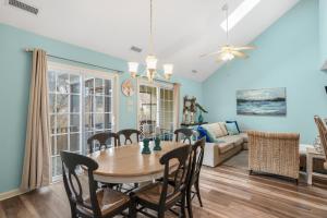 a dining room and living room with a table and chairs at Seas the Day - Water views, Shared pool! in Chincoteague
