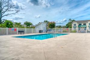 a swimming pool in a yard with a fence at Seas the Day - Water views, Shared pool! in Chincoteague