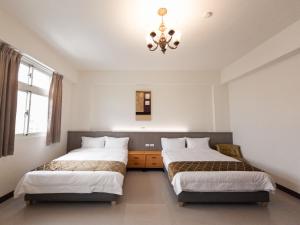 A bed or beds in a room at Yearning Homestay