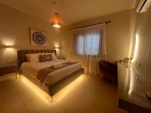 a bedroom with a bed and a window with lights at Matteo Villa Limassol Cyprus in Limassol +43 photos