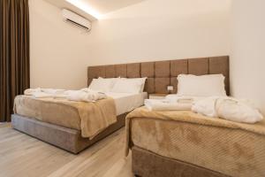 Postel nebo postele na pokoji v ubytování ZANI'S VILLA
