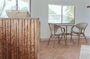 a dining room with a table and two chairs at Quinta del Mar Crystal Beach in Tintipan Island