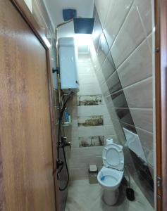 a small bathroom with a toilet and a light at Dream Loft in the center of Varna in Varna City