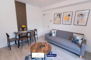 a living room with a couch and a table at Award-Winning Four Bedrooms House, Parking, WiFi By Derby Short Term Rental Short Lets & Serviced Accommodation Derby in Derby