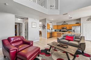 a living room with a couch and a table at 7BDM Prvt Pool Villa - Gated Resort 10min to Disney in Kissimmee