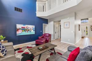 a living room with a couch and a table at 7BDM Prvt Pool Villa - Gated Resort 10min to Disney in Kissimmee +42 photos
