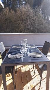a blue table with wine glasses on a balcony at EL MIRADOR - Ferienwohnung Nähe Nürburgring - Eifel - Ahr - Rhein - RENOVIERT in Kempenich