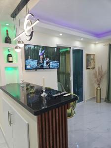a kitchen with a tv on the wall at Luxury Studio in San Isidro +16 photos