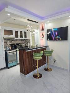 a kitchen with a counter and two stools in it at Luxury Studio in San Isidro