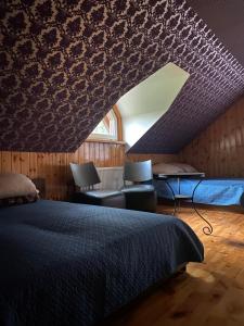a bedroom with a large bed and a window at Dzūkų sodžius in Snaigupė