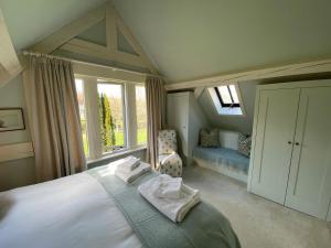 a bedroom with a large bed and a window at The Barn at Frog Pond Farm in Salisbury