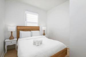 a bedroom with a white bed with white pillows at Contemporary 2BR Retreat in MTL Village in Montréal