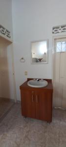 a bathroom with a sink and a mirror at Casa en conjunto Flandes 3 Habitaciones in Flandes