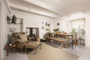 a living room with a table and a dining room at 8 Millpool in Mousehole