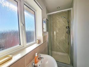 a bathroom with a sink and a shower at Boughton 3 Bed Semi by Fortuna Property in Gloucester +35 photos