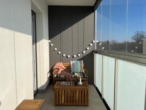 a chair on the balcony of a building at Luxury Apartment in the City Center - Klimatyzacja, Parking, Balkon, Atlas Arena, Wytwórnia, Piotrkowska in Łódź