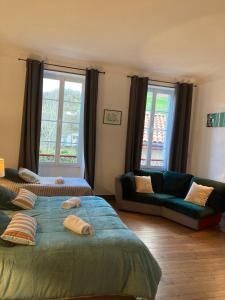 a living room with two beds and a couch at Maison Graciateguy in Saint-Étienne-de-Baïgorry