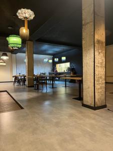 a large room with tables and chairs in it at Kakhri Resort in Mestia