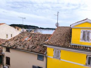 a view of roofs of buildings and a body of water at Guest House Barocco in Rovinj