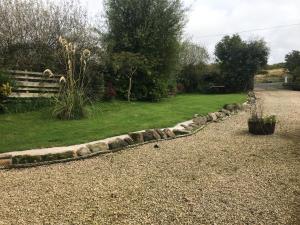 a garden with a rock border in a yard at Sanda View, Isle of Arran in Sliddery