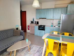 a kitchen and a living room with a couch and a table at Sunny Nest in Sparta