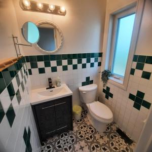 a bathroom with a toilet and a sink and a mirror at Cottage by the beach in Wasaga Beach
