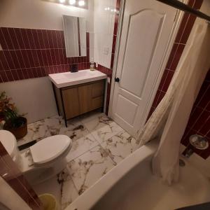 a bathroom with a toilet and a sink and a tub at Cottage by the beach in Wasaga Beach +17 photos