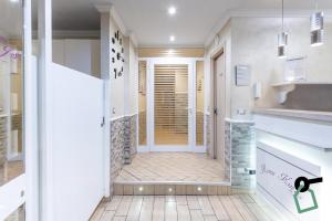 a hallway with a door leading to a kitchen with tiles at HOTIDAY Room Collection - Roma Barberini in Rome