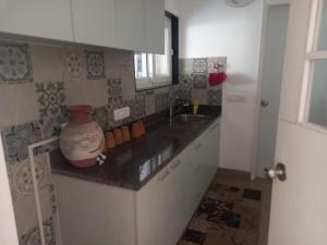 a kitchen with a sink and a vase on a counter at Savant in Gurgaon
